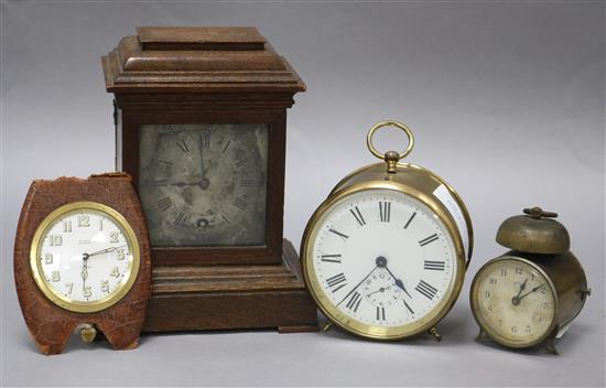 Two alarm clocks, a travel clock and a re-cased movement, 17cm